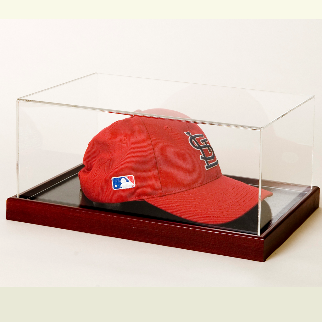 Baseball cap in acrylic display case with wood base