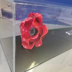 IBCC ceramic poppy with stem in a clear display case with black base