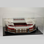 Model of Old Trafford stadium made from Lego building blocks in a clear display case.