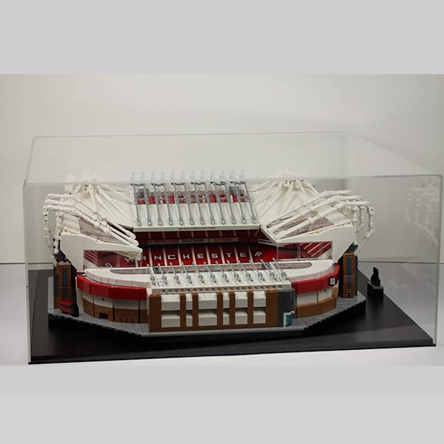 Model of Old Trafford stadium made from Lego building blocks in a clear display case.