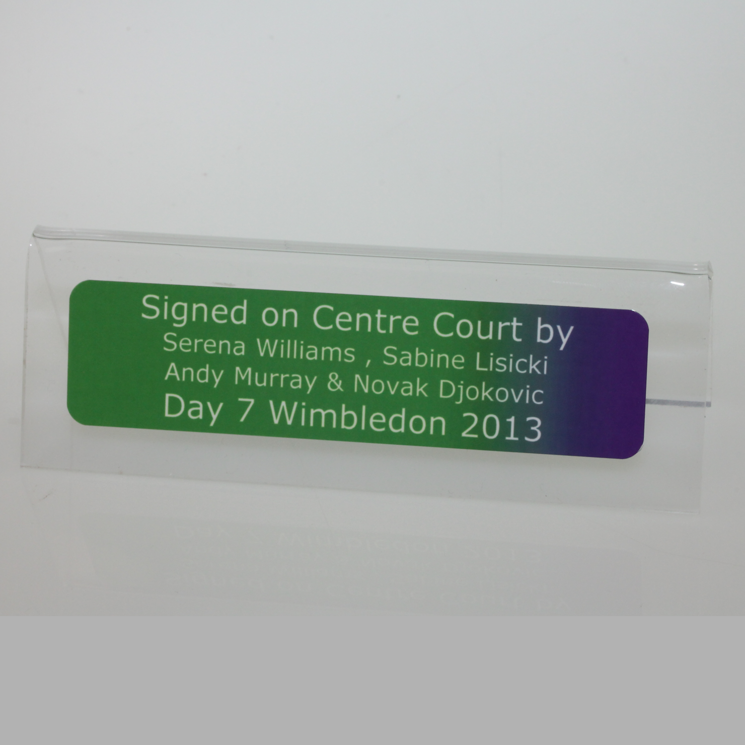 Plaque on stand with tennis player names and Wimbledon 2013 event details on a clear background