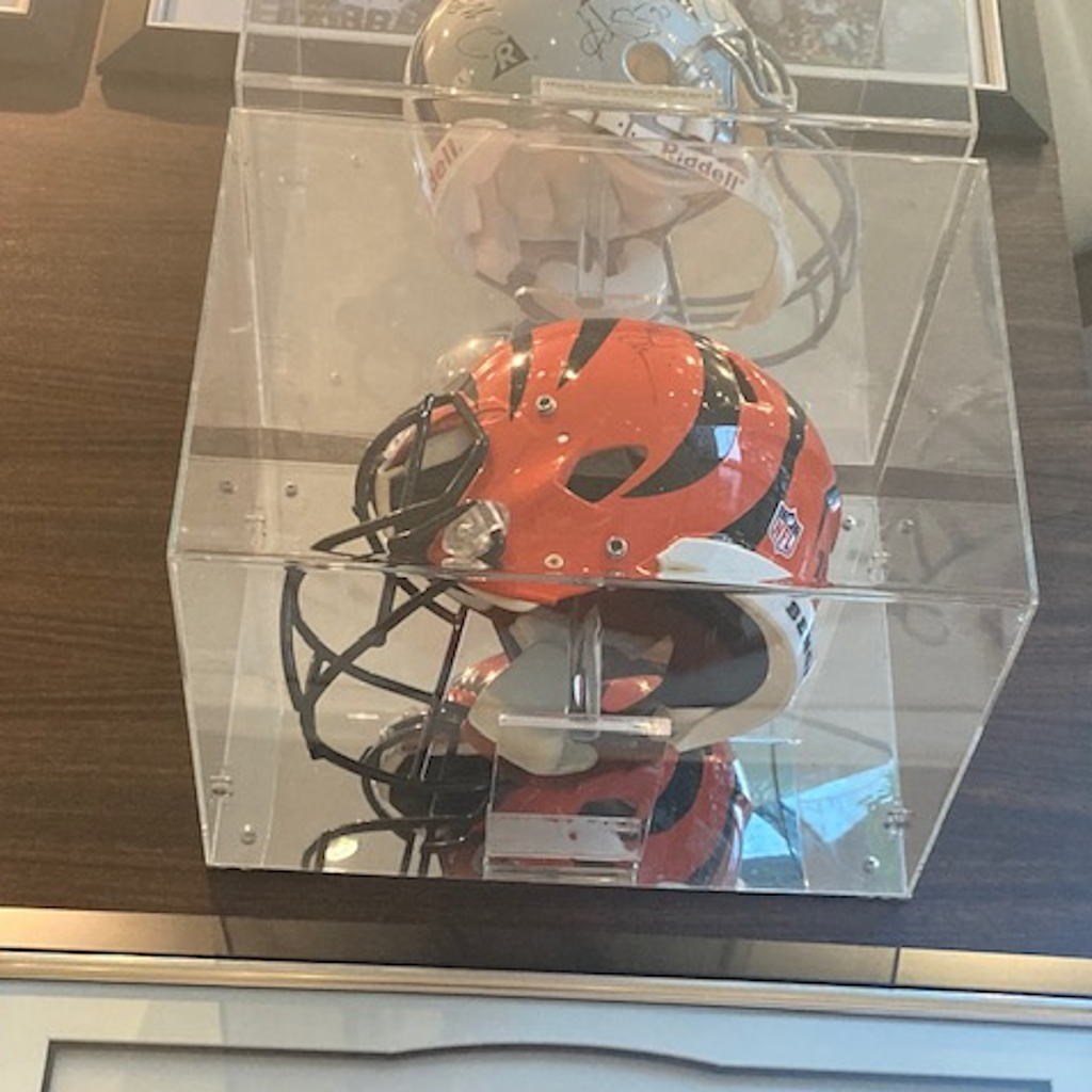 Full size NFL football helmet in a clear wall mount display case with mirror back
