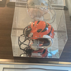 Full size NFL football helmet in a clear wall mount display case with mirror back