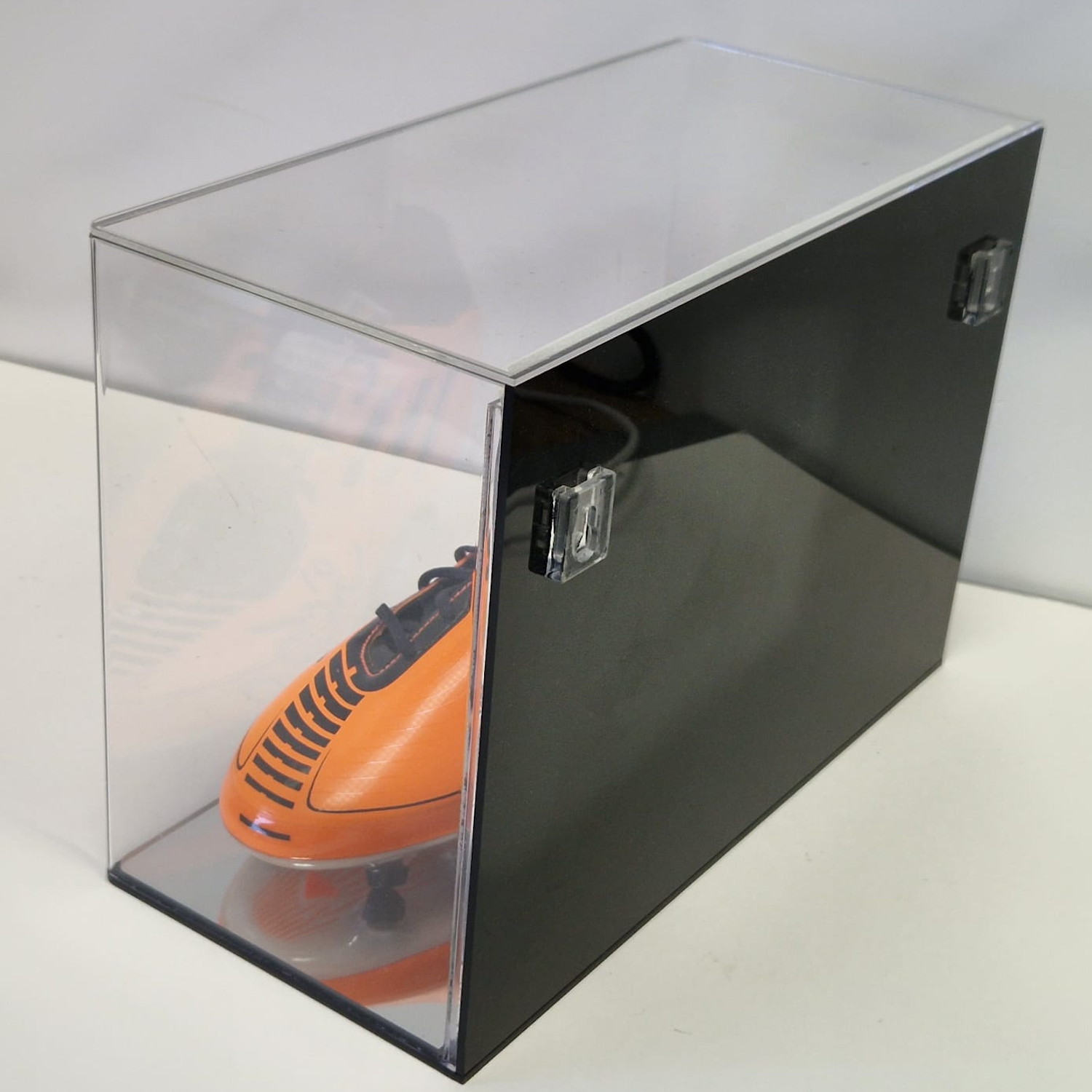 Signed Messi football boot in wall mount display case with background image back view